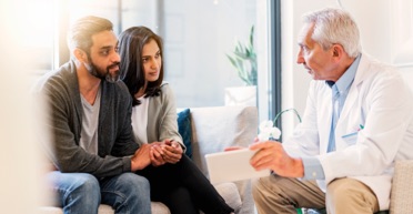 Doctor talking to couple about COPAXONE®.