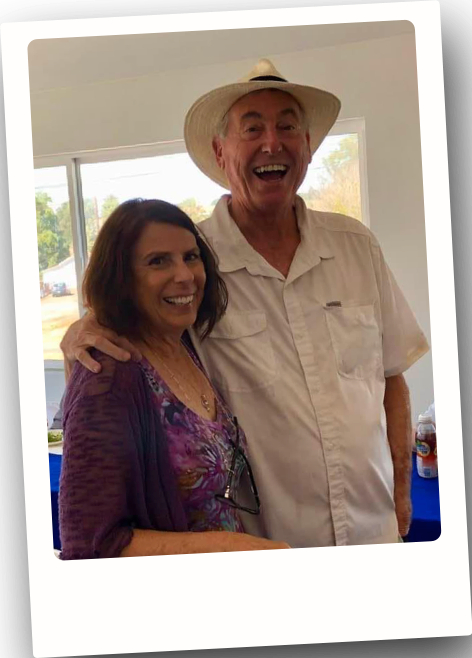 Therese and her husband standing together and smiling.