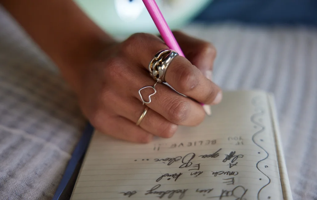 Close up of a hand writing in a notebook